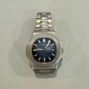 Gently used men’s steel luxury sports watch, automatic movement.